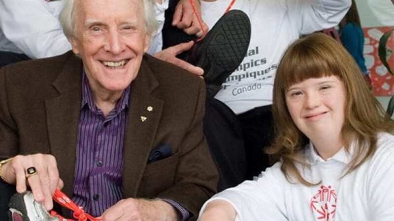 a man sitting next to young girl and both are smiling. 