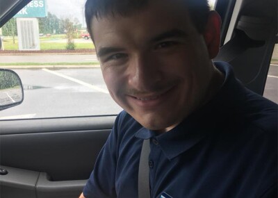 Jordan sitting in a car smiling for a selfie.