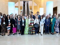 A group of people standing in a row for a photo. 