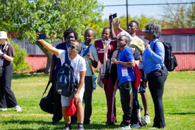 Participants take a group selfie during an outdoor Special Olympics youth leadership and engagement event.