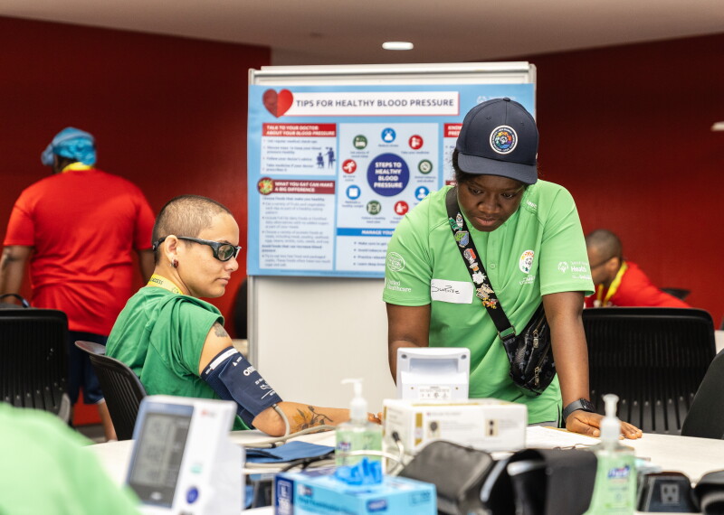 Athlete having blood pressure taken by a health care worker. 