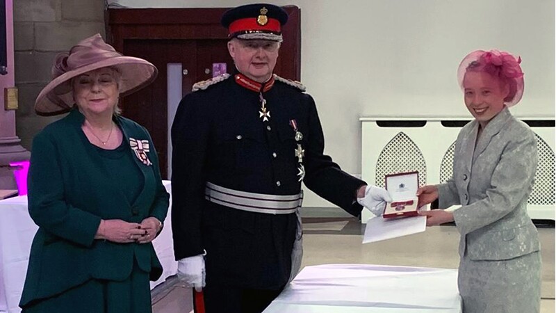 Kiera receiving the British Empire Medial from the lord-lieutenant. 