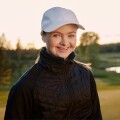 Special Olympics Finland golfer Wivan Atrila smiles to the camera