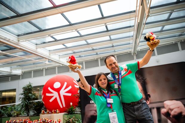 Two athletes side by side with an arm around each other