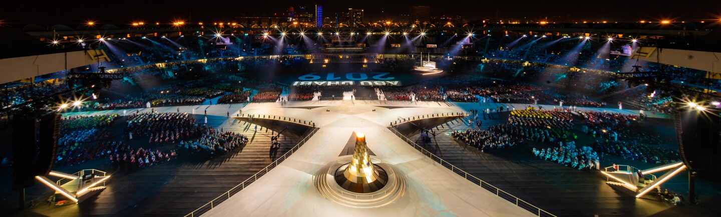 Stage in Abu Dhabi at the Abu Dhabi 2019 World Games; audience on either side of a lit stage.