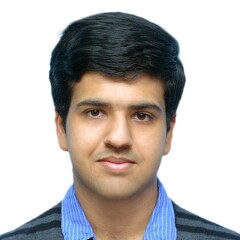 Haseeb standing for a professional photo.