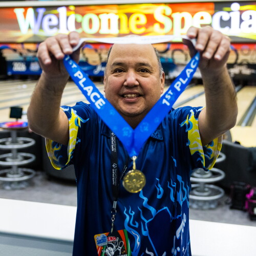 Athlete showing off medal. 