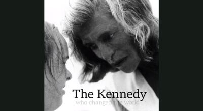 Eunice Kennedy Shriver looking at a young athlete.