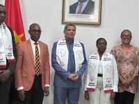 Six people standing and posing for the camera while wearing Special Olympics-branded scarfs 