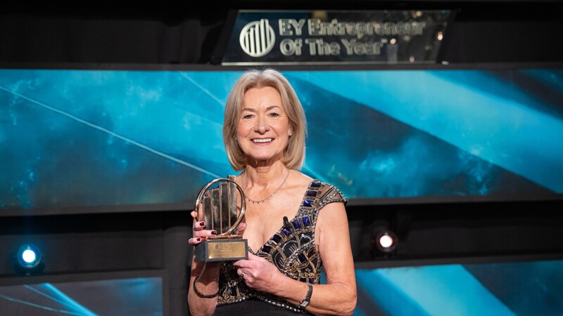 Mary Davis standing onstage with her award