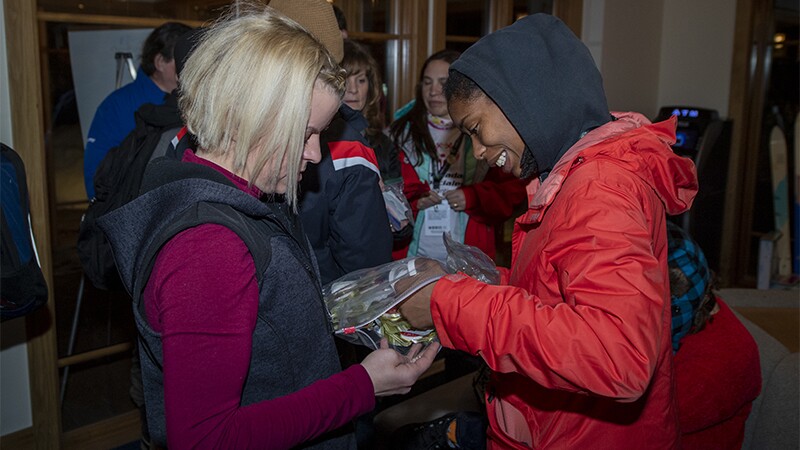 Daina Shilts (left) is sharing a bag of goodies with Latrice Pringle (right).