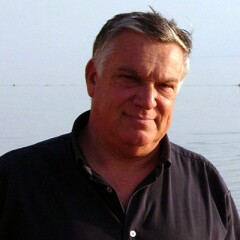Benedetto Saraceno standing in front of the ocean.
