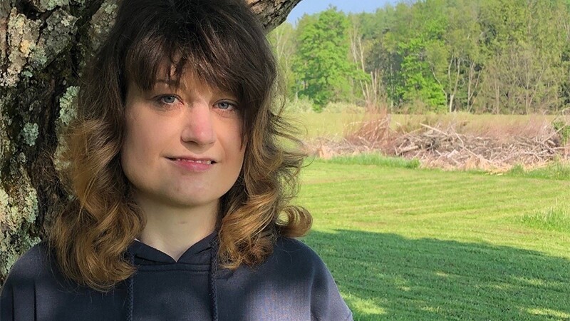 Johanna Schoeneck standing outside by a tree.