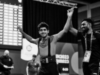 Man with his arms raised and celebrating. 
