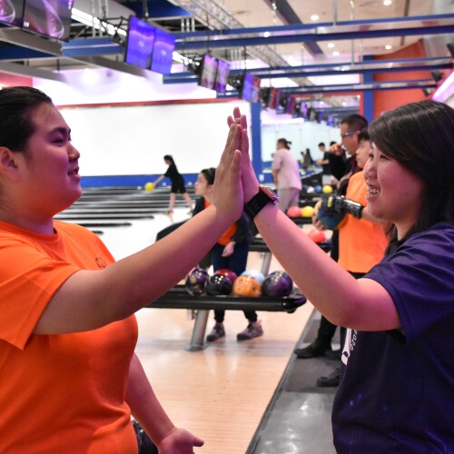 Two athletes celebrating at bowling. 