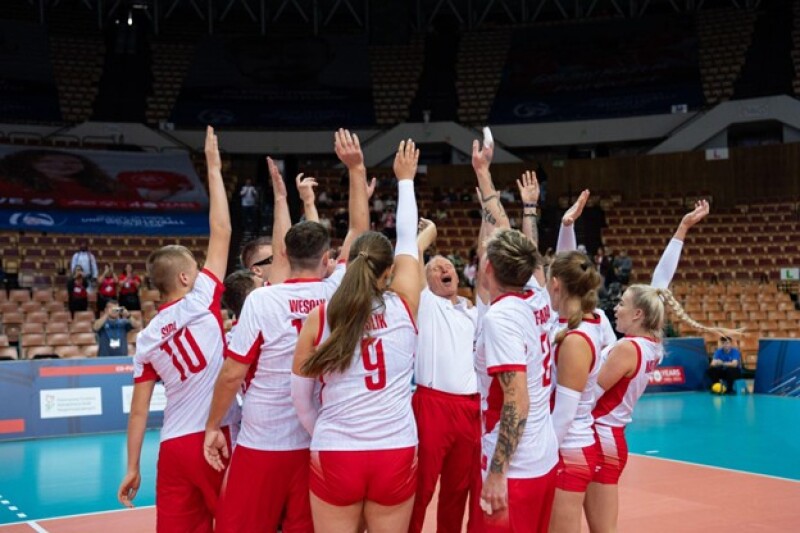 The Polish team celebrate their win with cheers in the arena