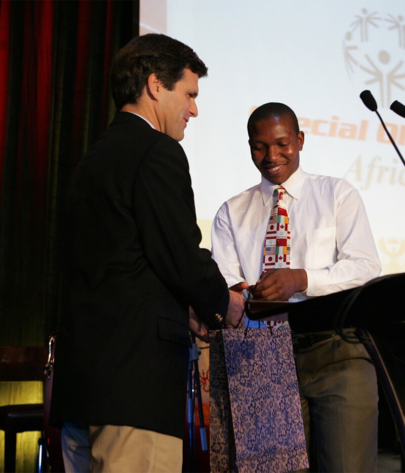 Ephraim Mohlakane and Tim Shriver on stage.