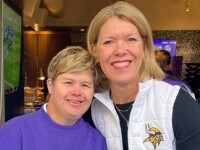 Two people stood side by side smiling