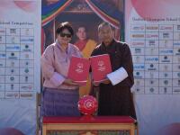 Two people holding documents. 