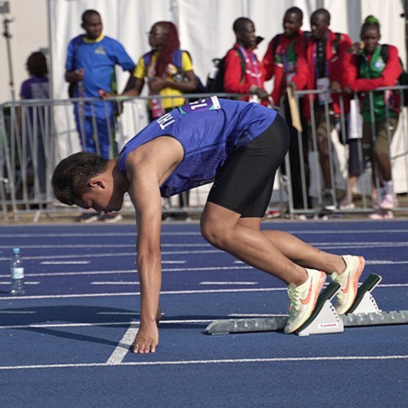 Young man preparing to start a race. 