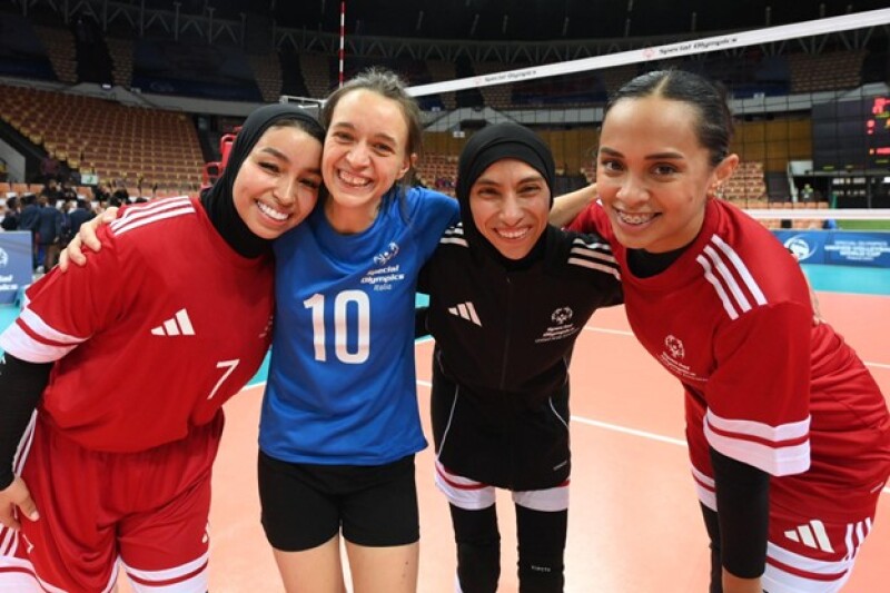 An Italian volleyball player embraces members of the UAE Team