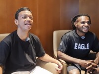 Two people sat in chairs next to each other facing forward