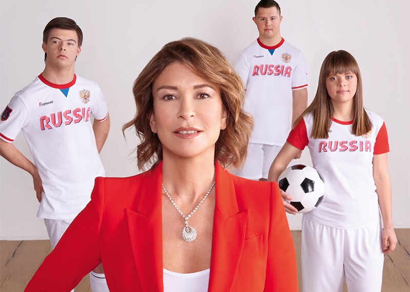Olga Slutsker and three athletes Masha Budina, Misha Stroyev, and Yan Ovsienko standing together.