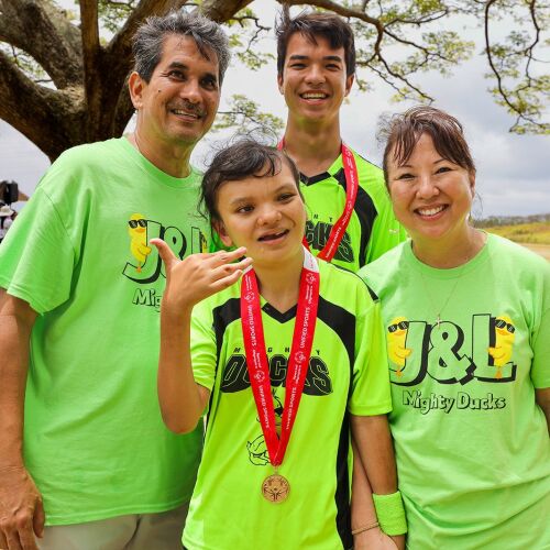 A group of four people wearing green t shirts