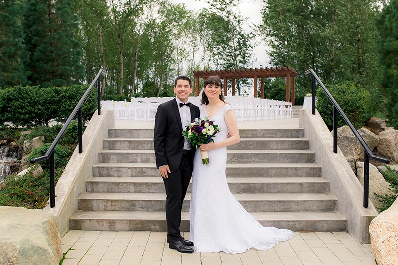Crystal and Matthew outside on in front of steps.