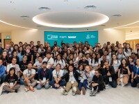 A large group of people in multiple rows, kneeling, squatting, and standing for a group photo. 