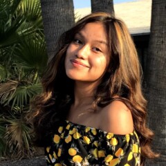 Rachelle outside in a floral dress.
