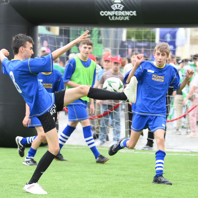 A young man kicking a ball while playing football