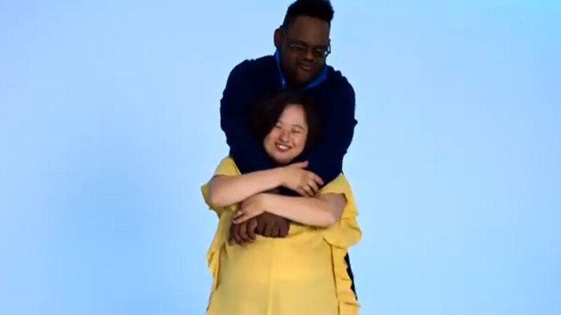 One individual hugging another