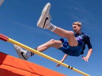 Man jumping over a bar. 