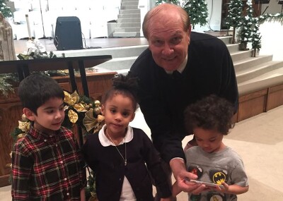 Pastor Roberts with three young children.