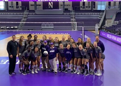 Coach Kevin and the Northwestern Women's Volleyball Team in a group picture.