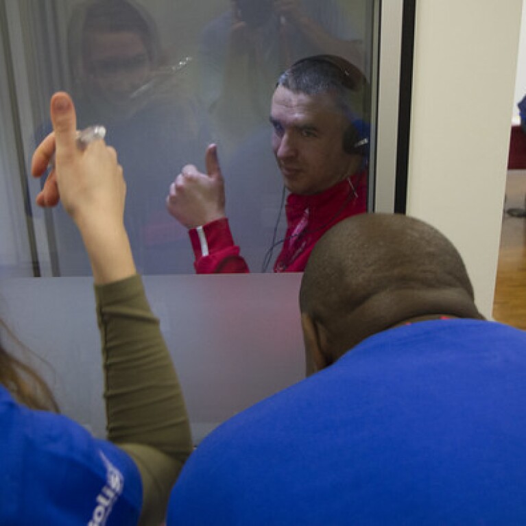 Athlete giving a thumbs up while having a hearing test performed on him.