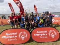 Special Olympics athletes pose for a photo in front of Special Olympics Slovakia banners. 