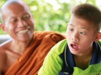 Young man sitting with a monk. 