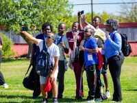 Participants take a group selfie during an outdoor Special Olympics youth leadership and engagement event.