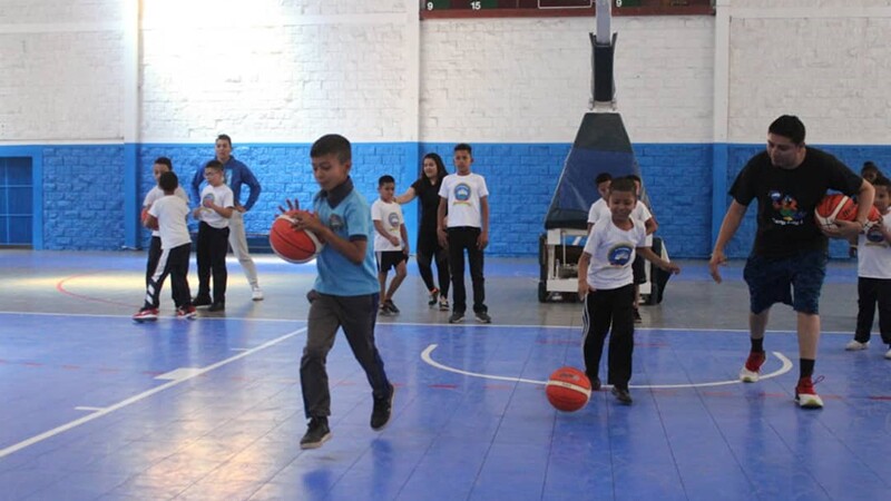 Young athletes practicing basketball on the court.