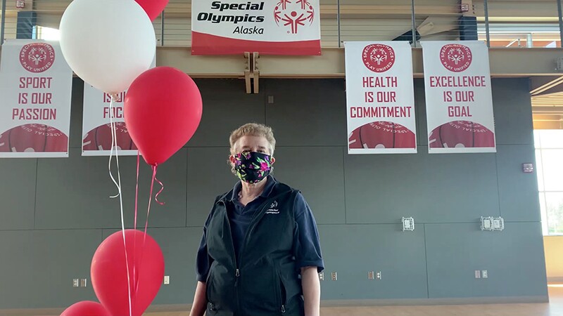 An older woman at the Special Olympics Alaska games wearing a face mask.