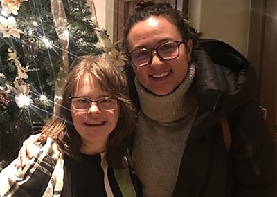 Stephanie and Hanna in front of a Christmas tree.