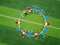 Group of athletes laying in a circle on a field