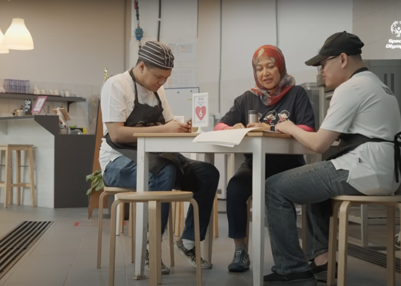 Three employees working together at a table