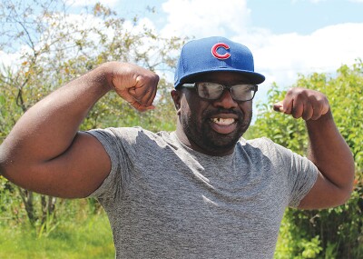Kevin outside flexing his biceps