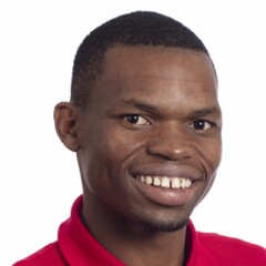 Nyasha standing for a professional photo wearing a red long sleeve Special Olympics polo.