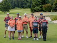 people standing in two rows on golf green
