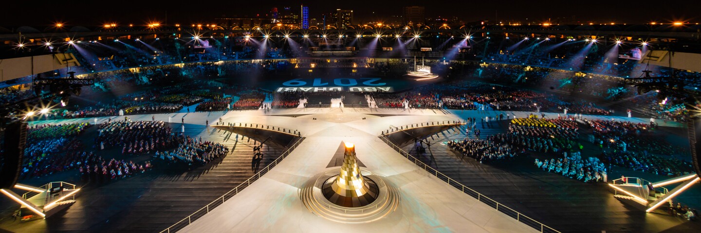 Stage in Abu Dhabi at the Abu Dhabi 2019 World Games; audience on either side of a lit stage.