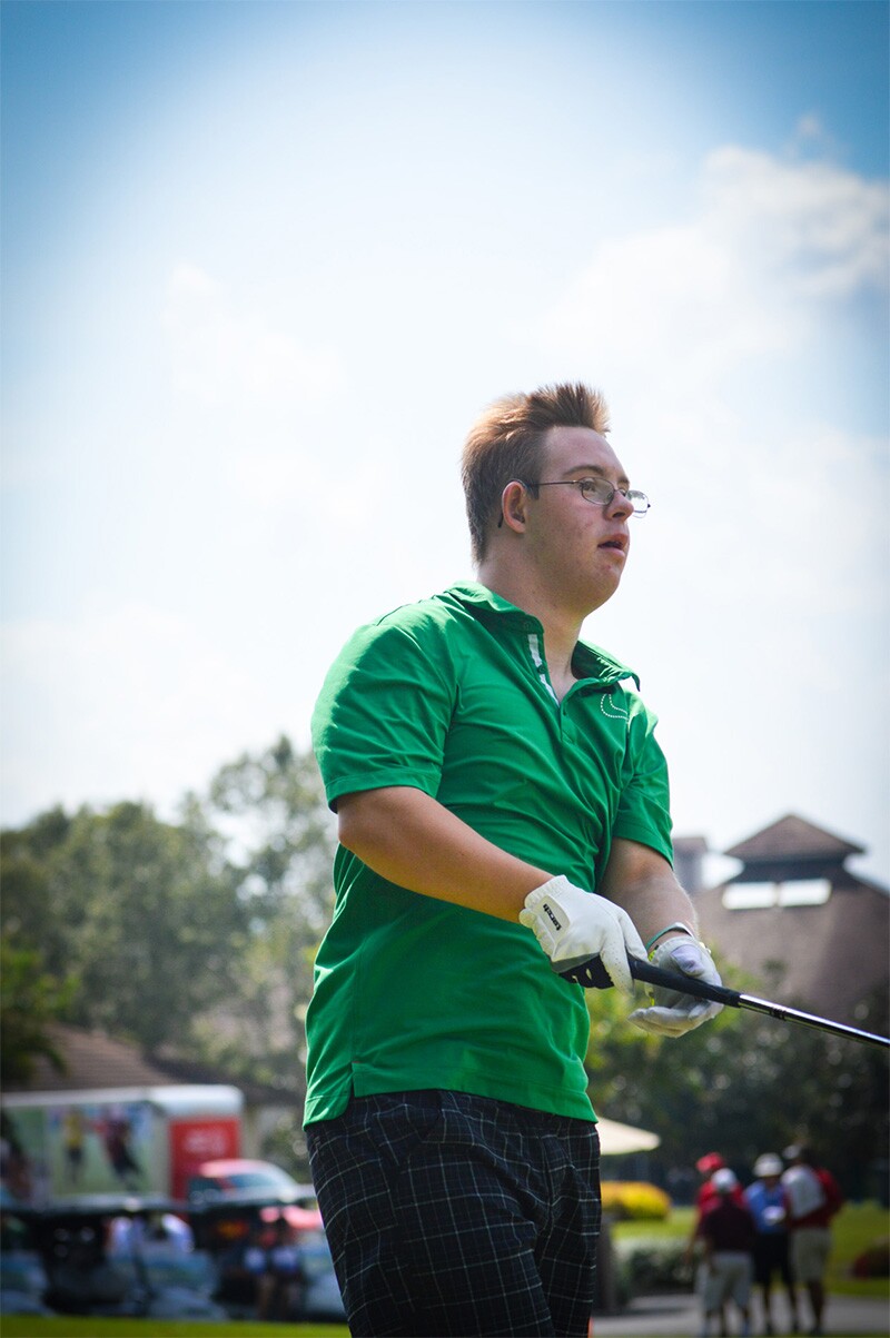Chris swings a golf club.